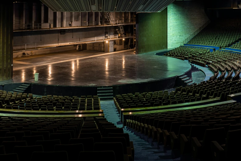 an empty theatre with rows of empty seats, a portrait, unsplash, conceptual art, dramatic green lighting, photography of gregory crewdson, oscar niemeyer, inside a grand