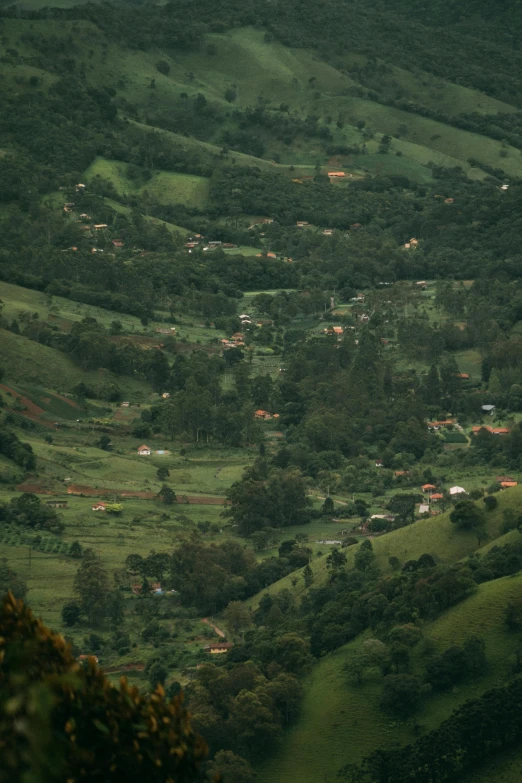 a view of a valley from the top of a hill, a tilt shift photo, by Osvaldo Romberg, colombia, dan eder, show, mid shot photo