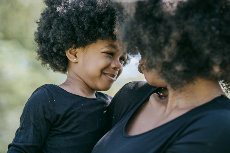 a woman holding a child in her arms, pexels contest winner, natural hair, looking at each other mindlessly, avatar image, manuka