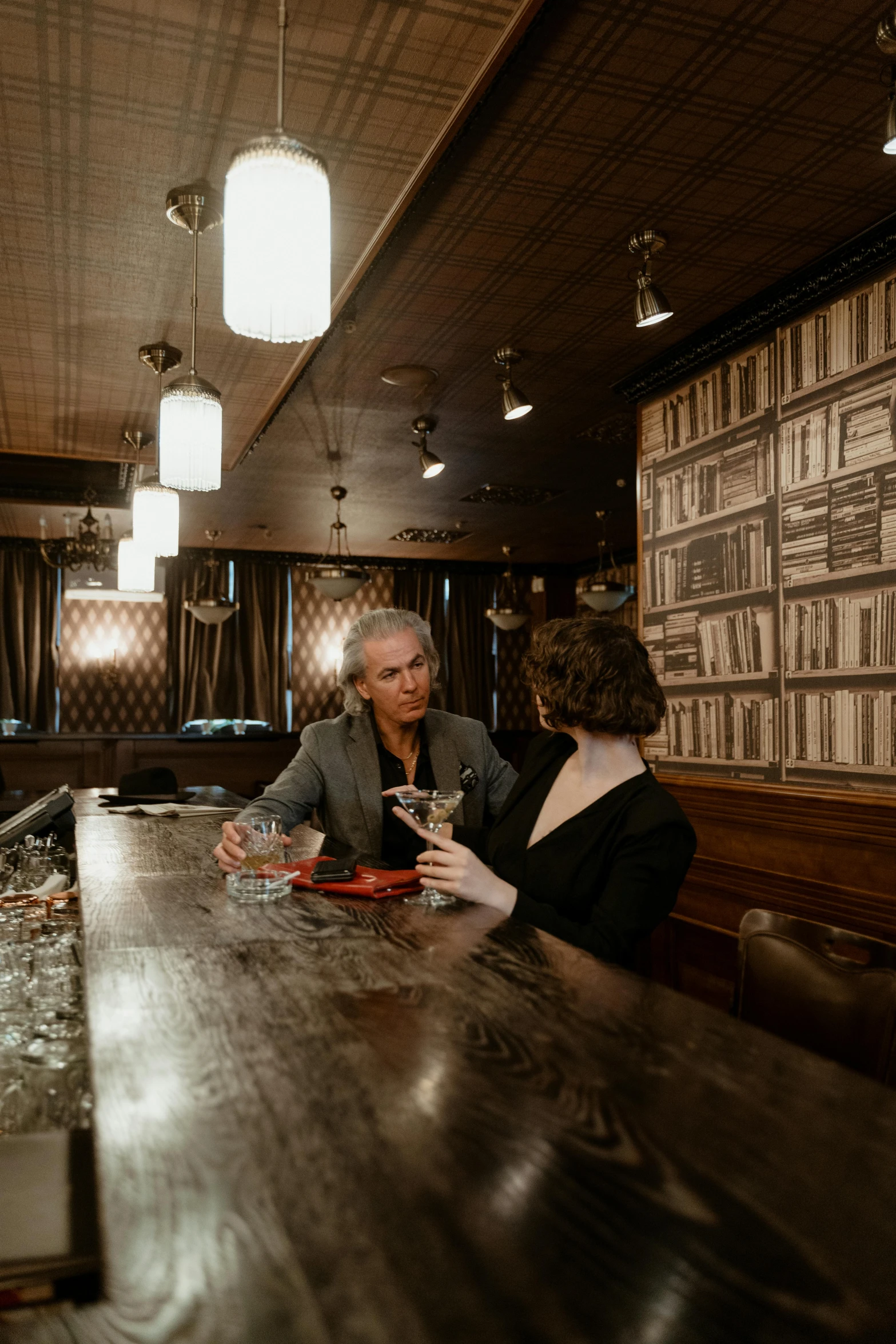 a man and a woman sitting at a bar, a portrait, unsplash, art nouveau, with one vintage book on a table, panoramic shot, anomalisa, parlor