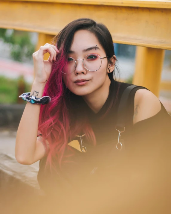 a woman with pink hair and glasses sitting on a bench, inspired by helen huang, trending on pexels, androgynous face, colorful]”, asian women, black and red hair