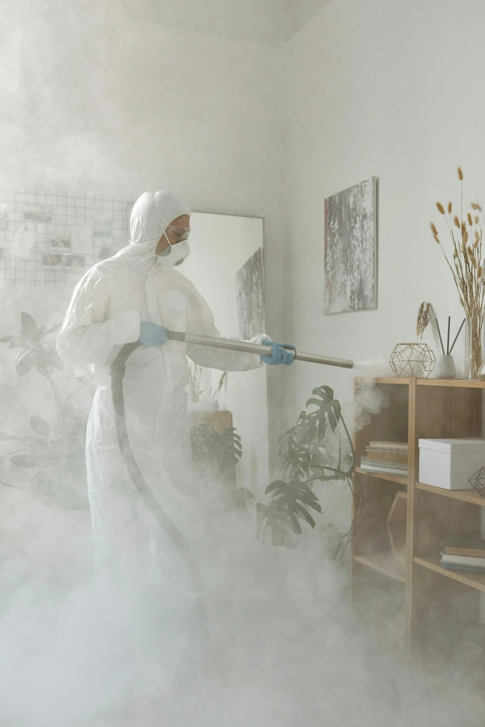 a person in a white suit is cleaning a room, misting, thumbnail, covid, derealisation