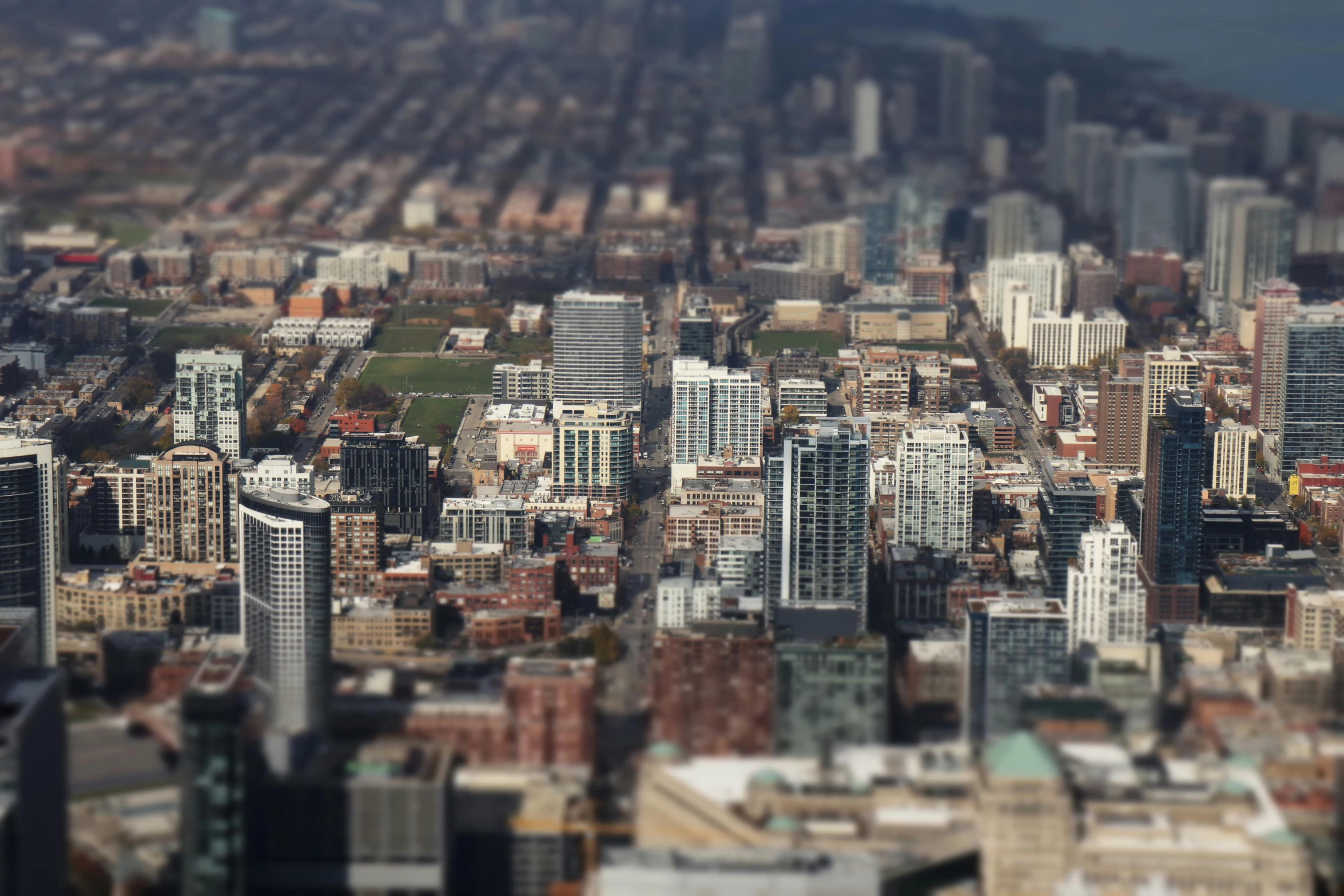 a view of a city from the top of a building, a tilt shift photo, by Robbie Trevino, pexels contest winner, photorealism, chicago, “wide shot, a quaint, petite