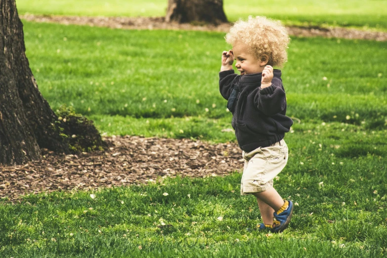 a little boy that is standing in the grass, pexels, happening, walking at the park, a blond, thumbnail, celebrating