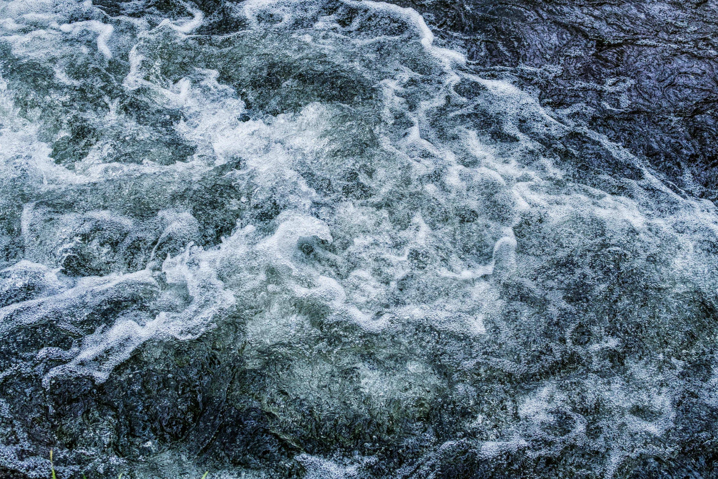 a man riding a surfboard on top of a river, an album cover, unsplash, process art, turbulent water, ignant, full frame image, textures