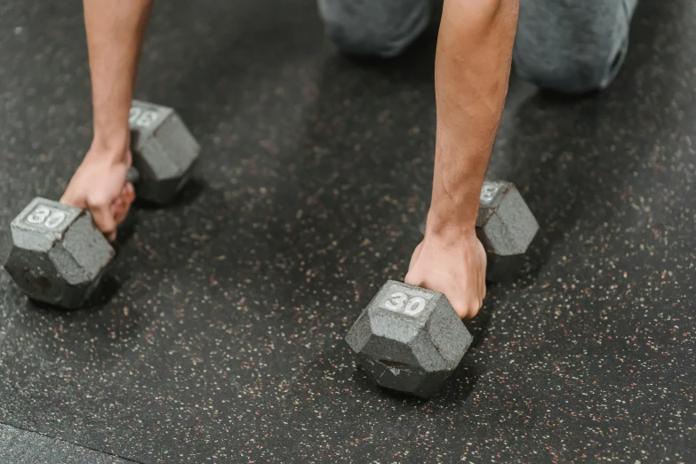 a man squatting down with a pair of dumbbells, by Anna Findlay, pexels contest winner, hurufiyya, paw pads, background image, 4-dimensional, a high angle shot