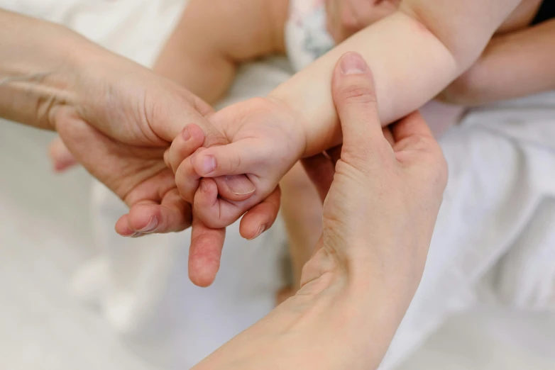 a close up of a person holding a baby's hand, local conspirologist, profile image, thumbnail, many hands