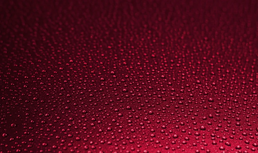 a close up of water droplets on a red surface, pixabay, minimalism, maroon metallic accents, ultradetailed, gradient maroon, covered