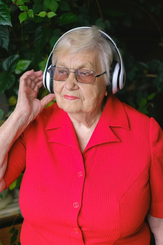 a woman in a red shirt is wearing headphones, an elderly, no cropping, say ahh, paul barson