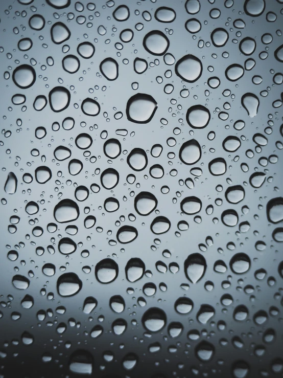 a close up of water droplets on a window, by Greg Rutkowski, trending on unsplash, minimalism, made of nanomaterials, grey, made out of rain, today\'s featured photograph 4k