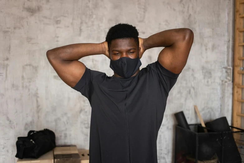 a man in a black shirt and a black face mask, a picture, wearing fitness gear, stressful, ( ( dark skin ) ), anthracite