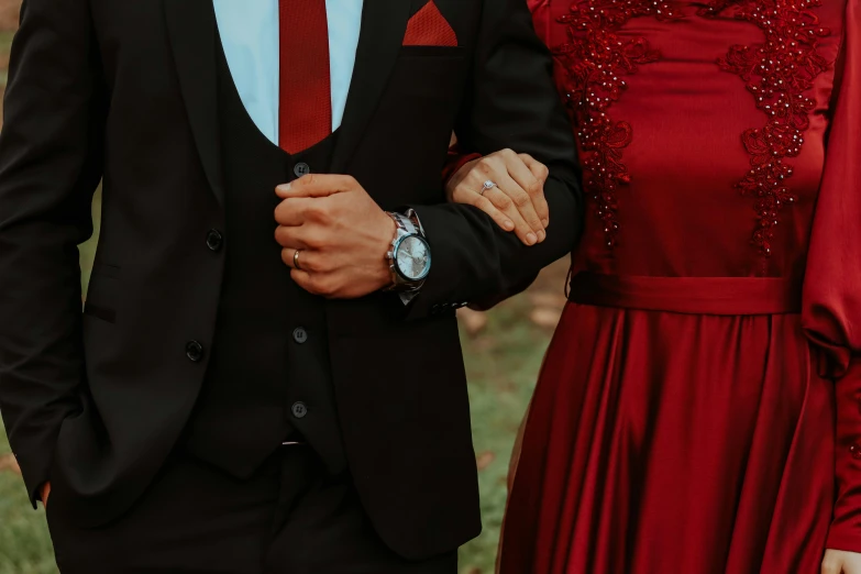 a man in a tuxedo and a woman in a red dress, pexels, detailed clothing, wearing a watch, modestly dressed, instagram post