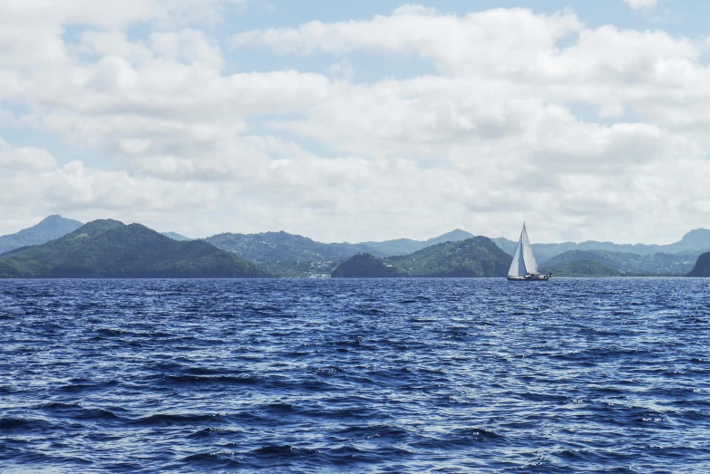 a sailboat in the middle of a large body of water, inspired by Miyagawa Chōshun, pexels contest winner, picton blue, samoan features, ignant, john pawson