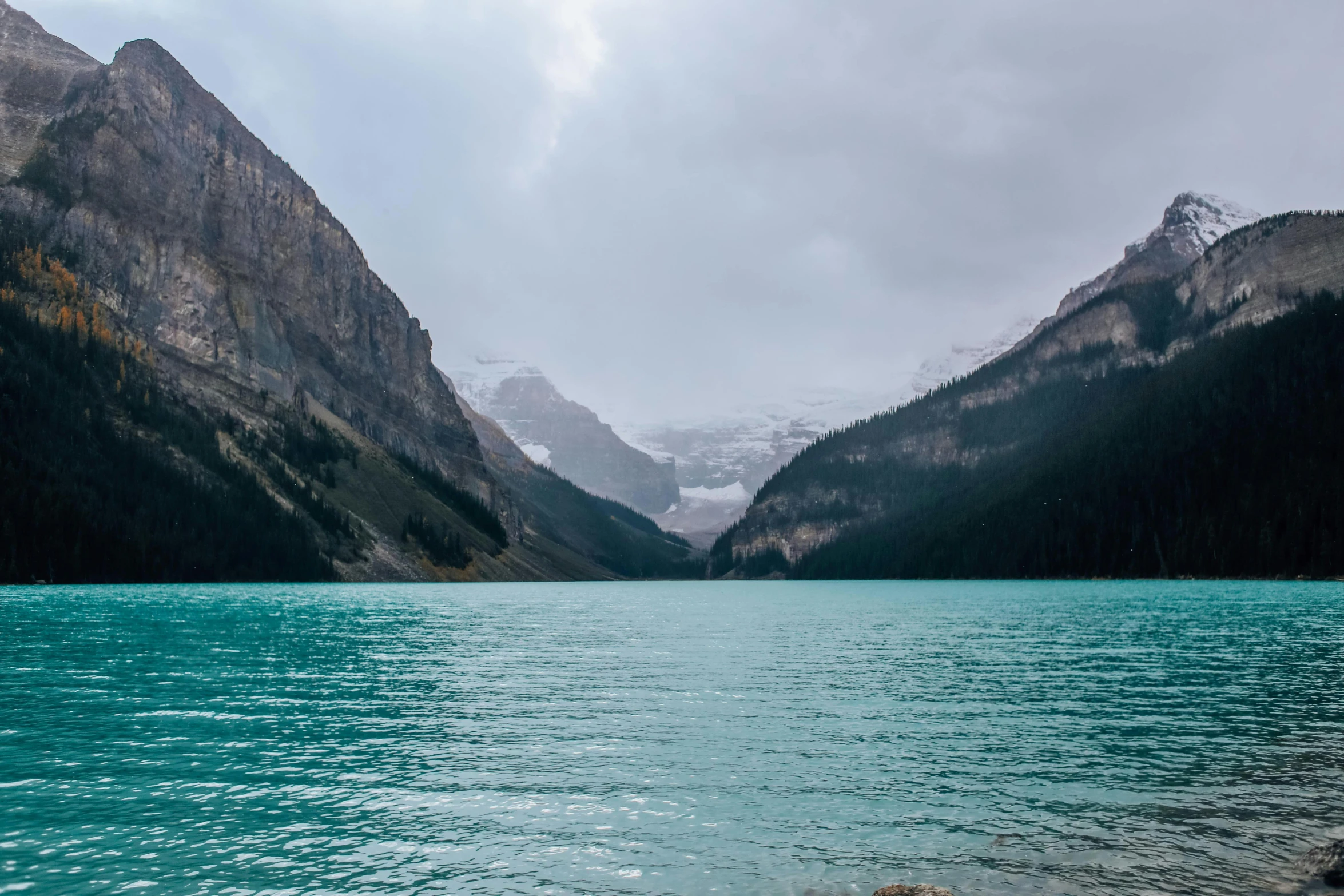 a body of water with mountains in the background, by Sophie Pemberton, pexels contest winner, hurufiyya, banff national park, wall of water either side, teal, photo of emma watson