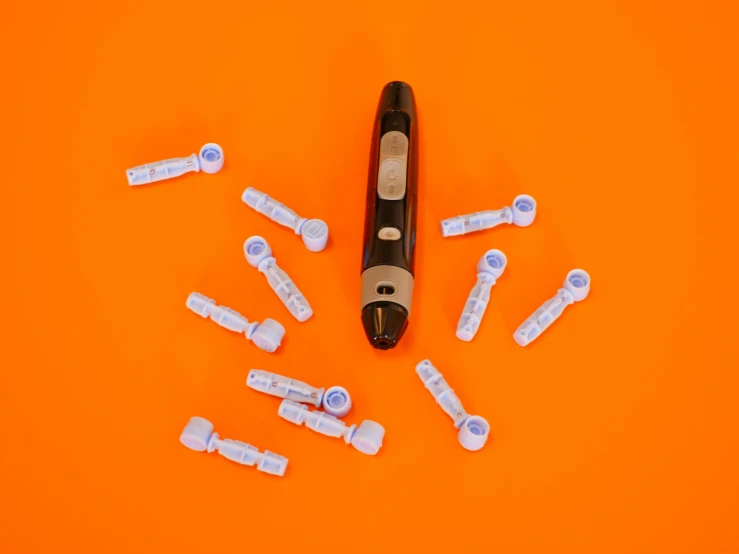 a close up of a toothbrush on an orange surface, by Gavin Hamilton, pexels contest winner, dada, many cryogenic pods, knolling, sharpie, robotic limbs on floor