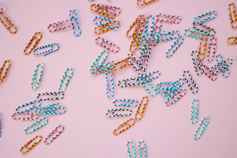 a bunch of paper clips laying on top of a table, by Emma Andijewska, trending on pexels, maximalism, polka dot, candy treatments, striped, ffffound