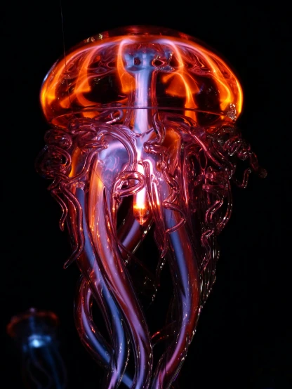 a glass jelly sitting on top of a table, a portrait, by Tony Szczudlo, unsplash, process art, highly detailed fire tendrils, detailed glowing red implants, super nova octopus, closeup - view