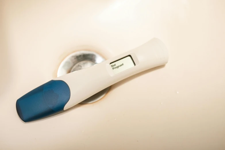 a close up of a digital thermometer in a sink, by Dan Frazier, trending on reddit, happening, membrane pregnancy sac, portrait n - 9, half blue, blank