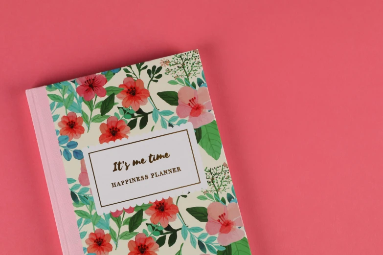 a book sitting on top of a pink surface, floral pattern, the rapture, official product photo, happily tired