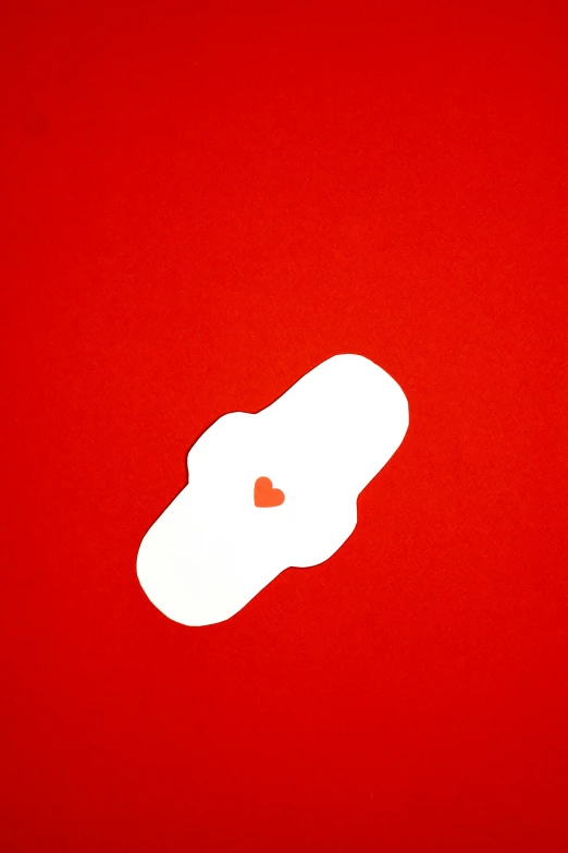 a pair of shoes sitting on top of a red surface, offering the viewer a pill, (heart), zoomed in, large)}]