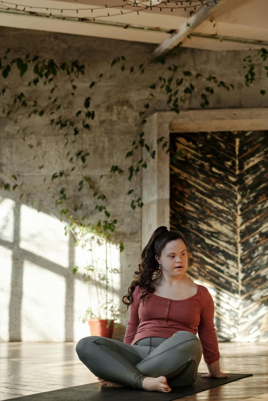 a woman sitting on a yoga mat in a room, inspired by Elsa Bleda, renaissance, in a monestry natural lighting, amongst foliage, pregnancy, concerned expression