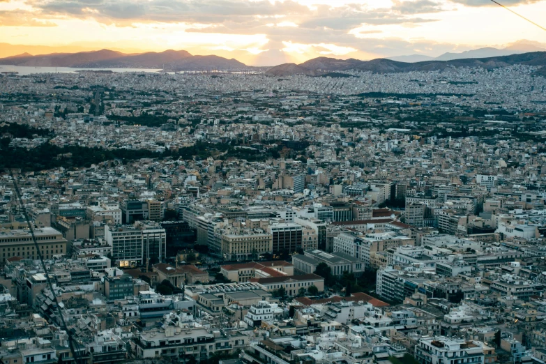 an aerial view of a city with mountains in the background, pexels contest winner, neoclassicism, square, greek, golden hour photo, view(full body + zoomed out)
