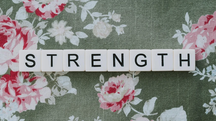 a scrabble with the word strength spelled on it, a cross stitch, by Emma Andijewska, trending on unsplash, graffiti, floral, lifting weights, pentagon, the strongest superhero
