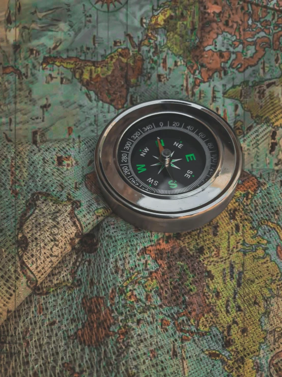 a compass sitting on top of a map, an album cover, by Kristian Zahrtmann, unsplash contest winner, instagram story, steam workshop maps, 1960s color photograph, sports photo