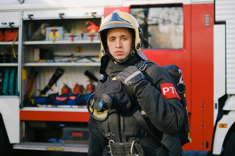 a firefighter standing in front of a fire truck, by Adam Marczyński, pexels contest winner, wearing a flying jacket, pewdiepie, 1990's photo, timothee chalamet