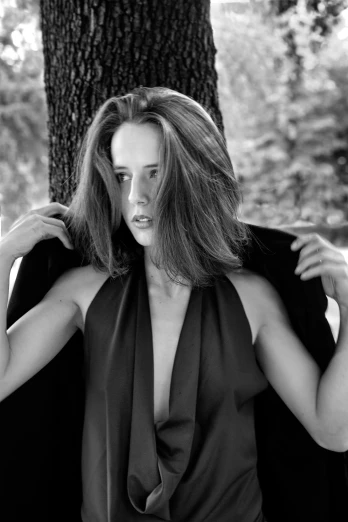 a black and white photo of a woman in a dress, a black and white photo, by Larry Fink, eva green, hair made of trees, square, sleek!!!