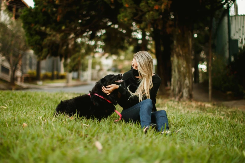 a woman sitting in the grass with a dog, manuka, profile image, black, professional image