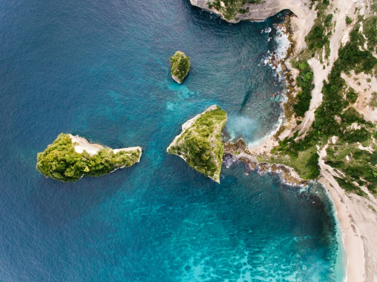 two small islands in the middle of a body of water, by Simon Marmion, pexels contest winner, capri coast, bali, middle close up composition, conde nast traveler photo