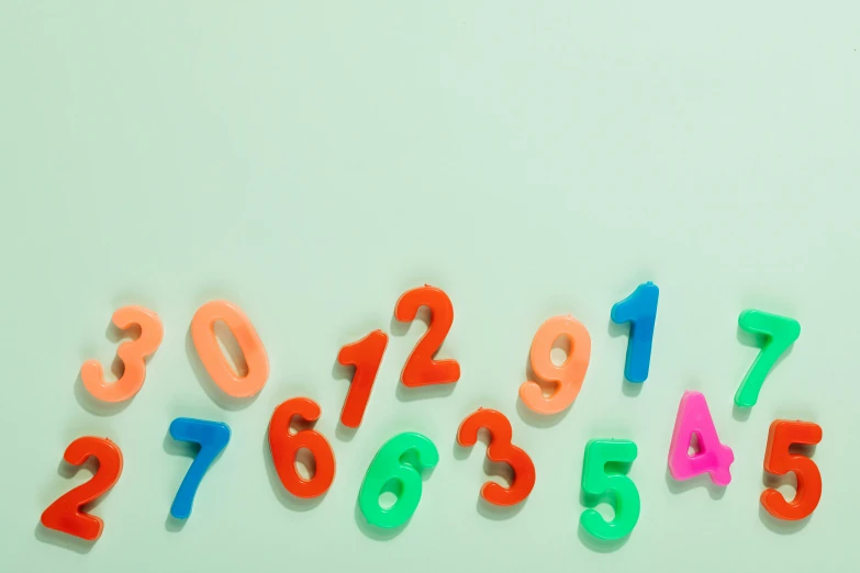 a group of multicolored numbers on a white surface, trending on unsplash, background image, multiple stories, turquoise pink and green, classroom background
