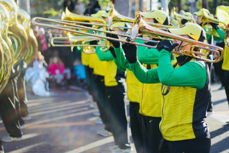 a group of people marching in a parade, an album cover, pexels contest winner, yellow and greens, brass instruments, sports photo, avatar image