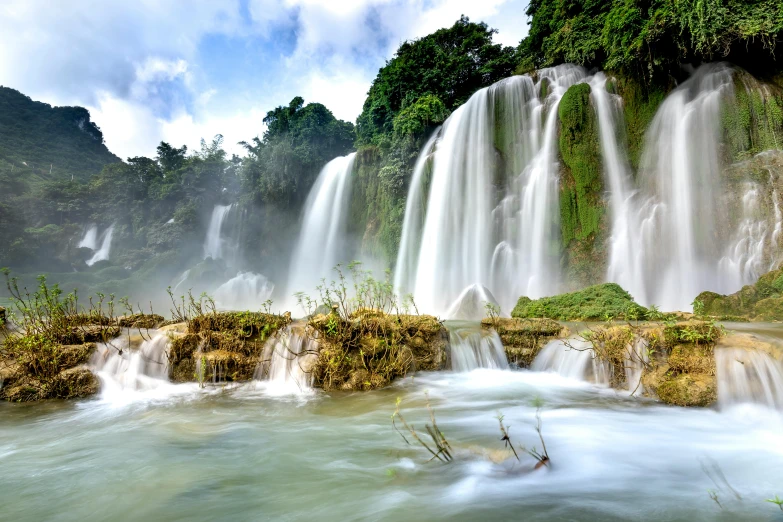 a waterfall in the middle of a lush green forest, an album cover, inspired by Lam Qua, pexels contest winner, hurufiyya, white travertine terraces, panoramic shot, cuba, hou china