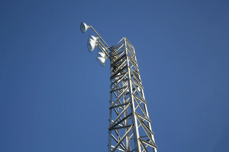 a cell phone tower against a blue sky, by Adam Marczyński, hurufiyya, square, commercial lighting, grey, low detail