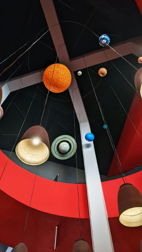 a bunch of lights hanging from the ceiling of a building, standing in the solar system, discovery zone, architectural photo, thumbnail