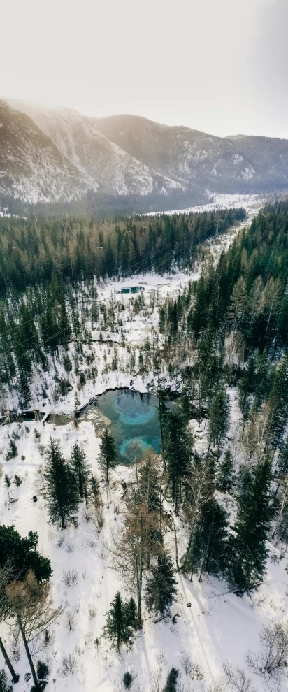 a bird's eye view of a snowy landscape, by Sebastian Spreng, pexels contest winner, hurufiyya, build in a forest near of a lake, thumbnail, 268435456k film, deep clear pools of water