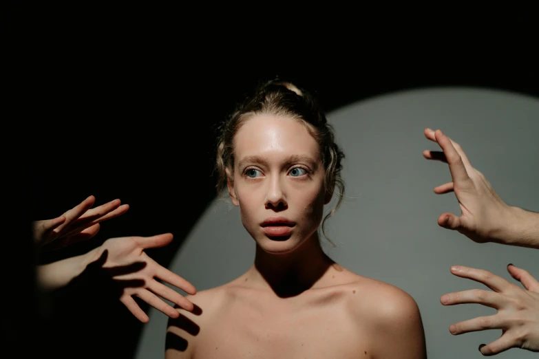 a woman holding her hands out in front of her face, inspired by Vanessa Beecroft, unsplash, hyperrealism, angela sarafyan, sydney sweeney, actor, ignant