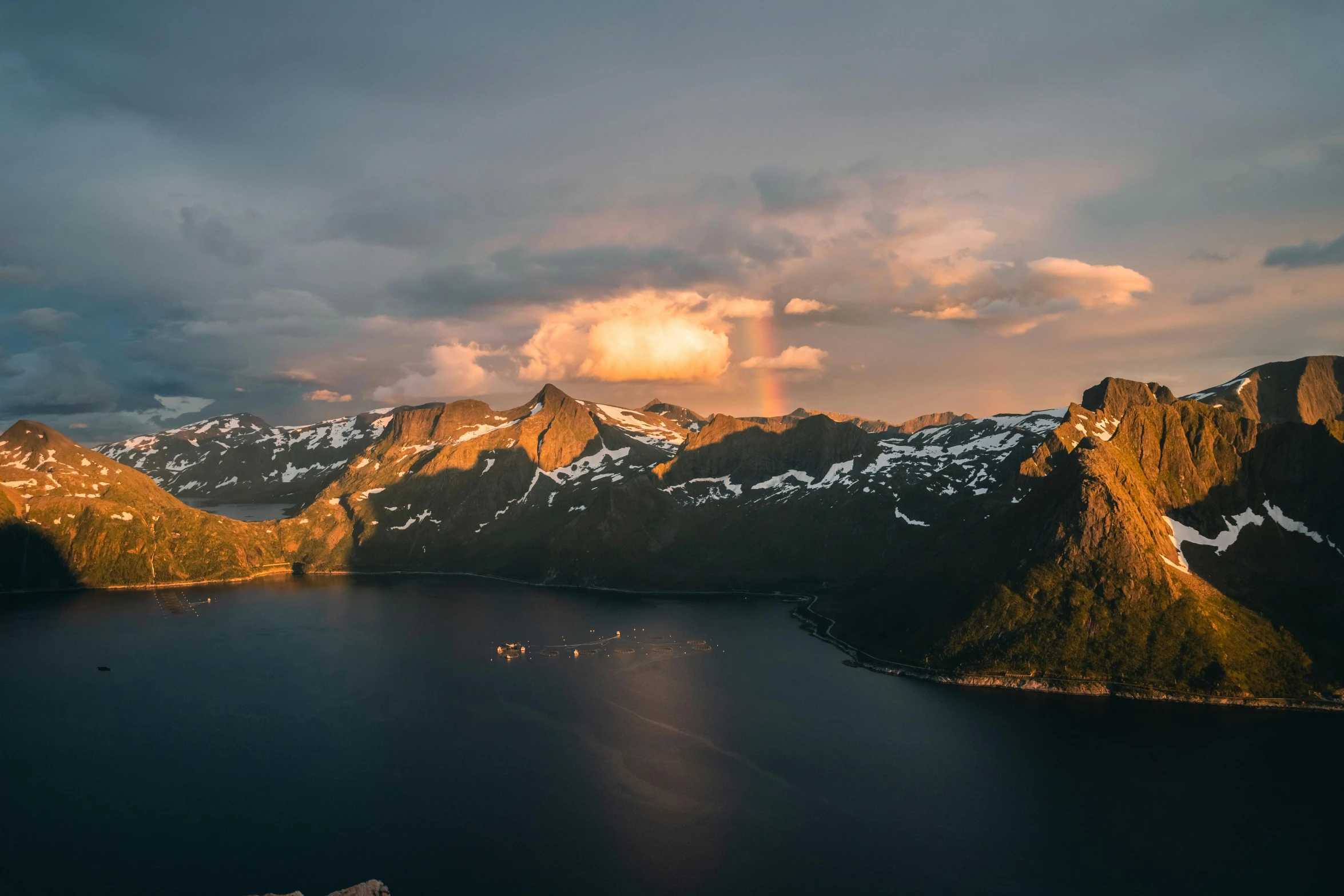 a large body of water surrounded by mountains, by Sebastian Spreng, pexels contest winner, romanticism, sunset light, fjords, drone photograpghy, distant mountains lights photo