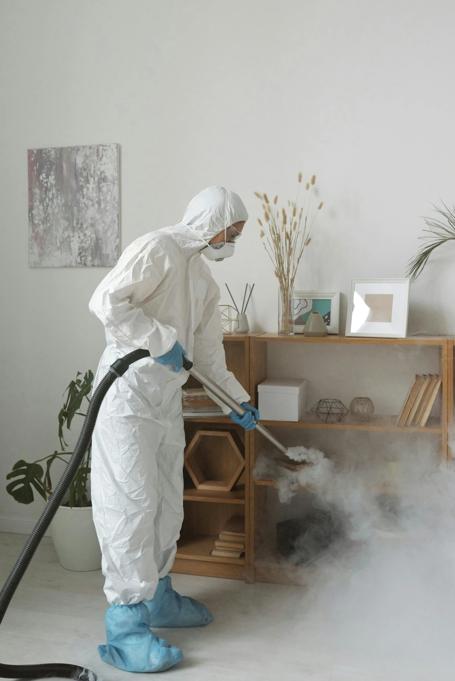 a person in a white suit is cleaning a room, dust in the air, wearing a robe, profile image, furniture