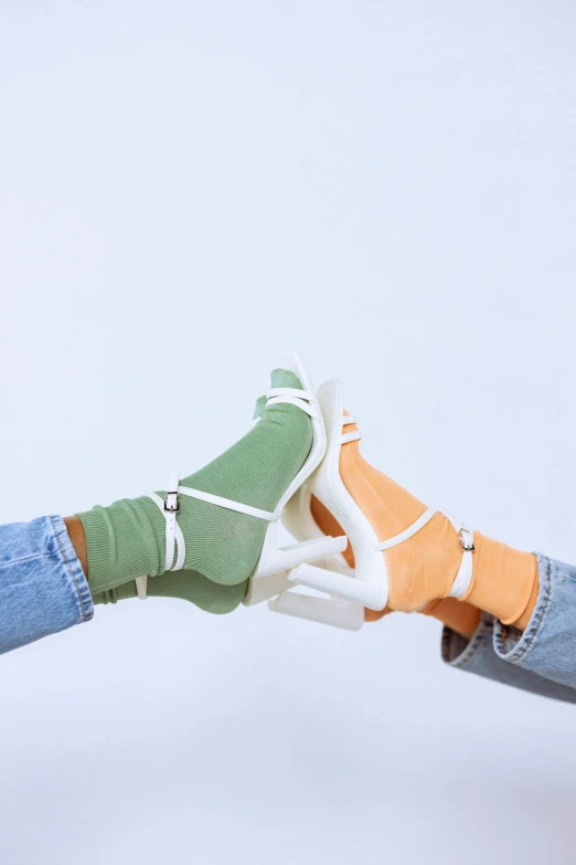 a person holding a tennis racquet in one hand and a tennis ball in the other, a colorized photo, by Carey Morris, trending on unsplash, renaissance, algae feet, holding each other hands, pastel clothing, white bandages on fists