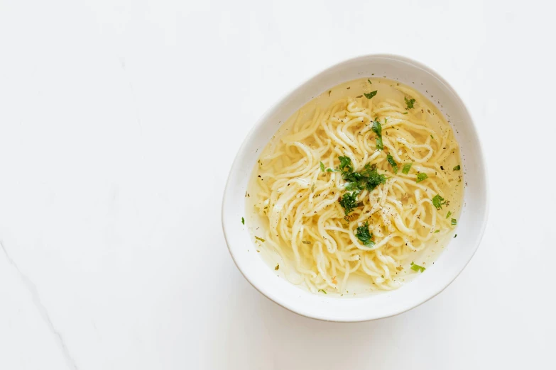 a white bowl filled with noodles and garnished with parsley, inspired by Géza Dósa, unsplash, renaissance, white backround, liquid gold, ignant, garis edelweiss