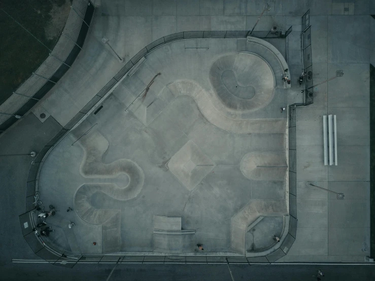 an aerial view of a skate park with ramps, unsplash contest winner, concrete art, grey, late evening, square, low quality photo