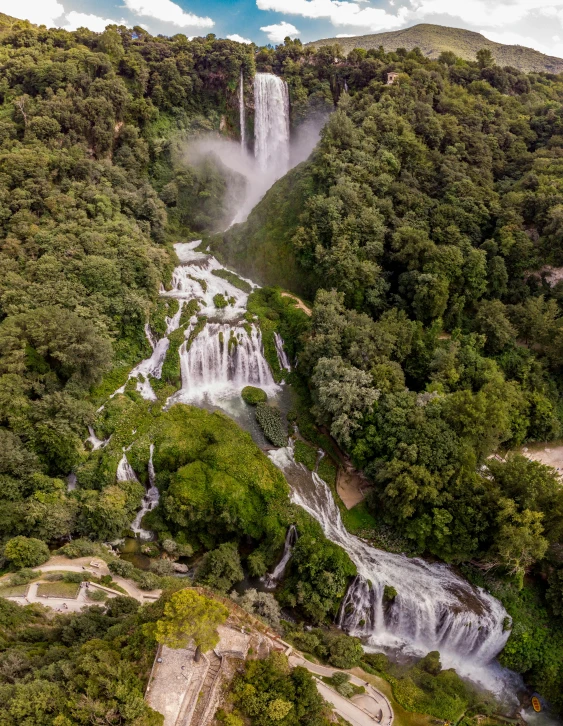 a waterfall in the middle of a lush green forest, an album cover, unsplash contest winner, hurufiyya, chile, helicopter view, thumbnail, historical setting