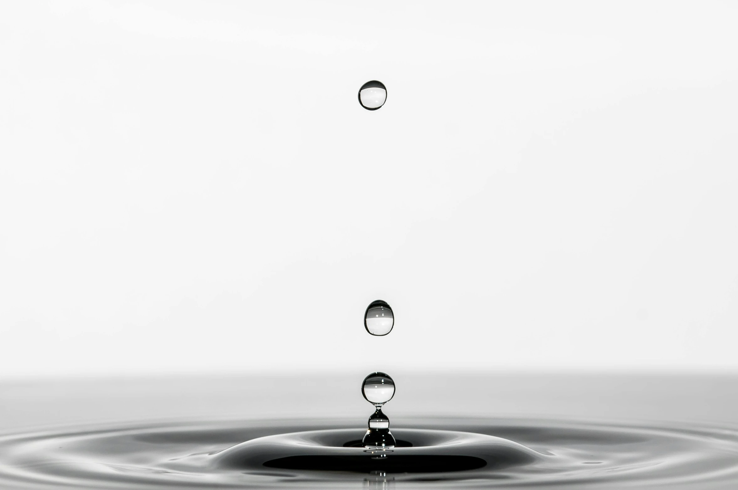 a black and white photo of a drop of water, by Jan Rustem, pixabay, minimalism, high quality topical render, cascade, made of water, set against a white background