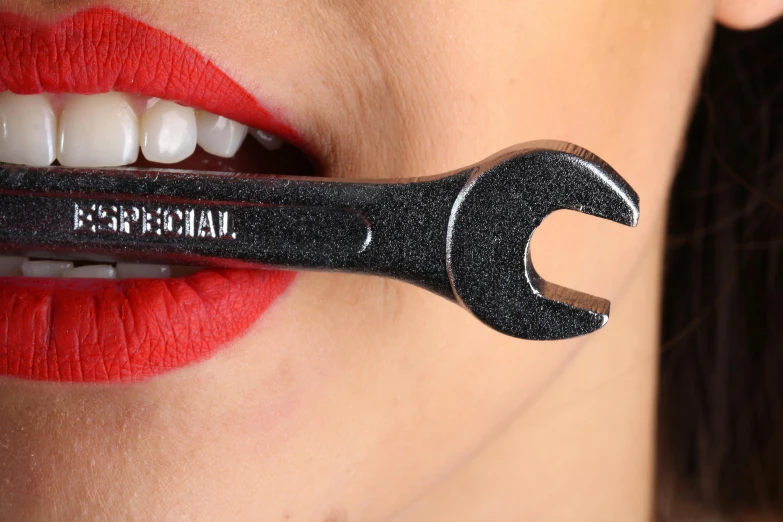 a close up of a woman with a wrench in her mouth, inspired by Man Ray, trending on pexels, photorealism, maybelline, detailed product image, bottom angle, professional product shot