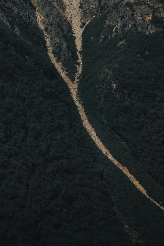 a plane that is flying over some mountains, an album cover, unsplash contest winner, land art, landslide road, 2 5 6 x 2 5 6 pixels, australian bush, the ground is dark and cracked