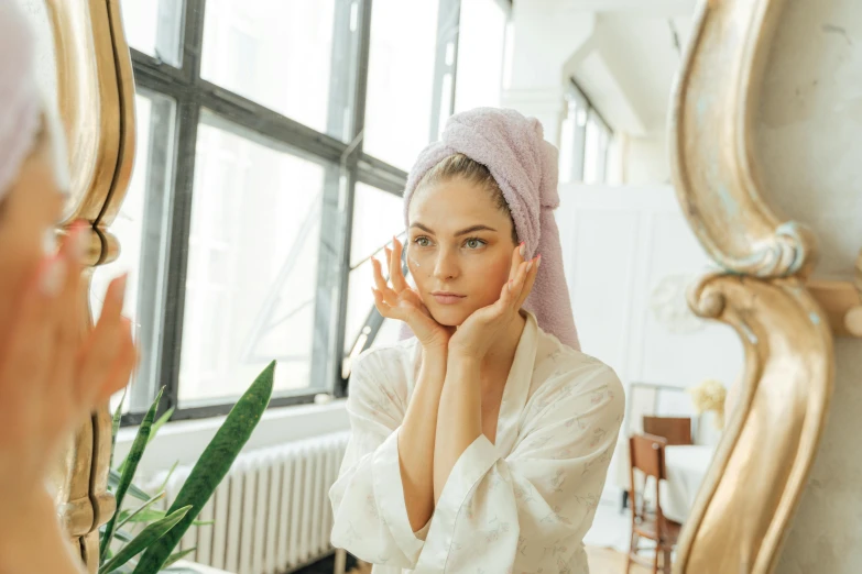 a woman with a towel on her head in front of a mirror, trending on pexels, renaissance, with backdrop of natural light, cosmetics, various posed, uploaded