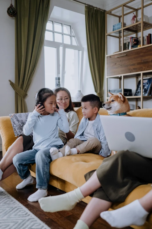 a group of children sitting on a couch with a laptop, pexels contest winner, asian female, husband wife and son, animals, avatar image
